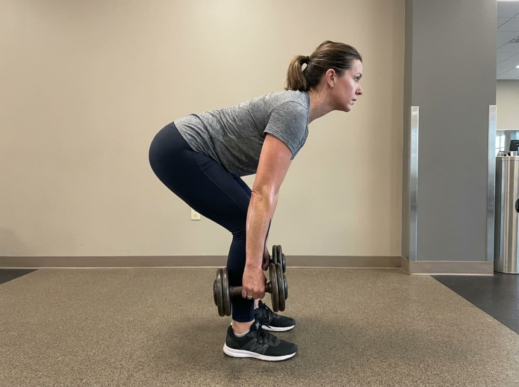 Woman performing deadlift exercise